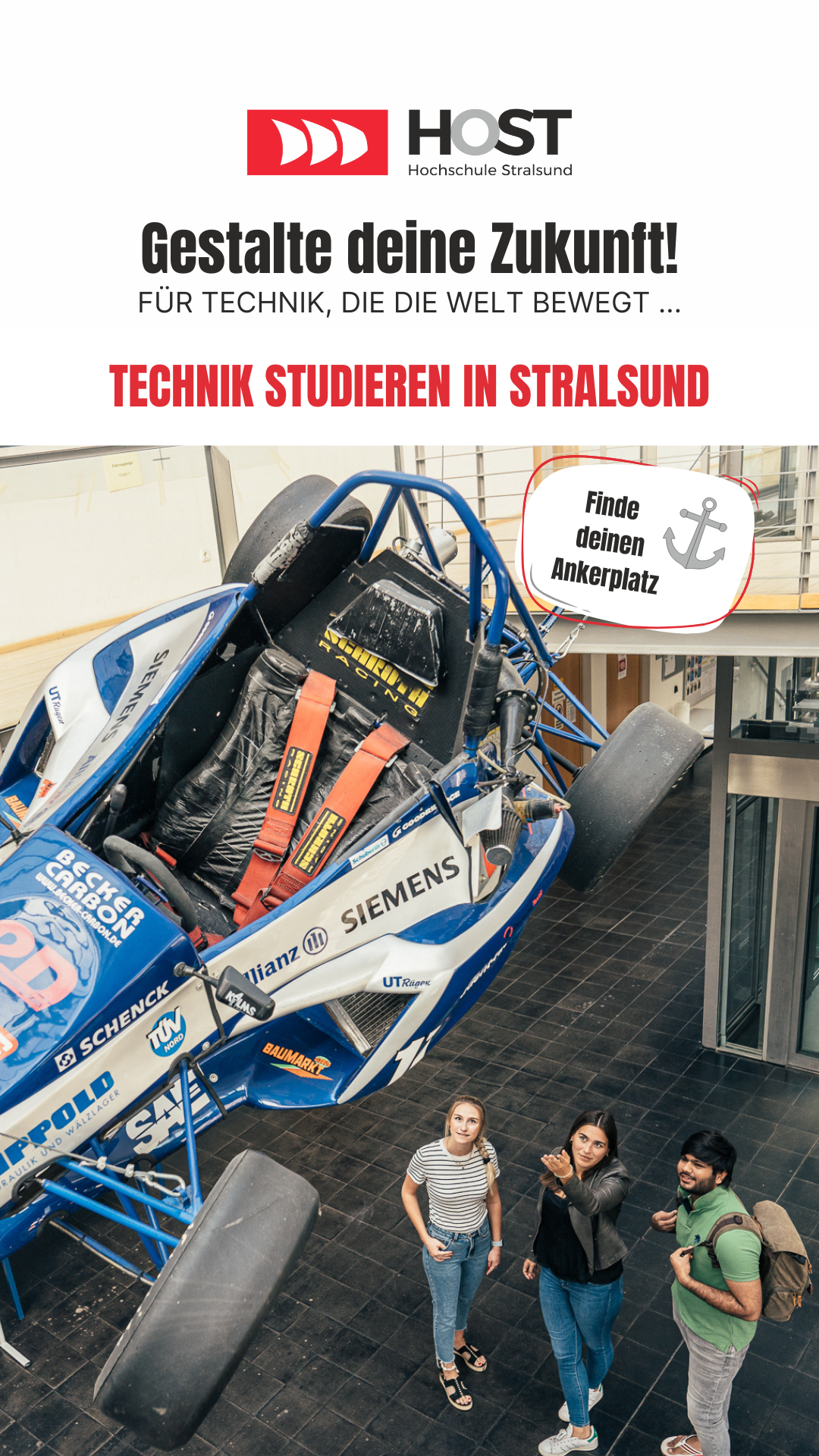 Display: A group of students stand in the foyer of the Faculty of Mechanical Engineering and talk about the racing car hanging from the ceiling above them.