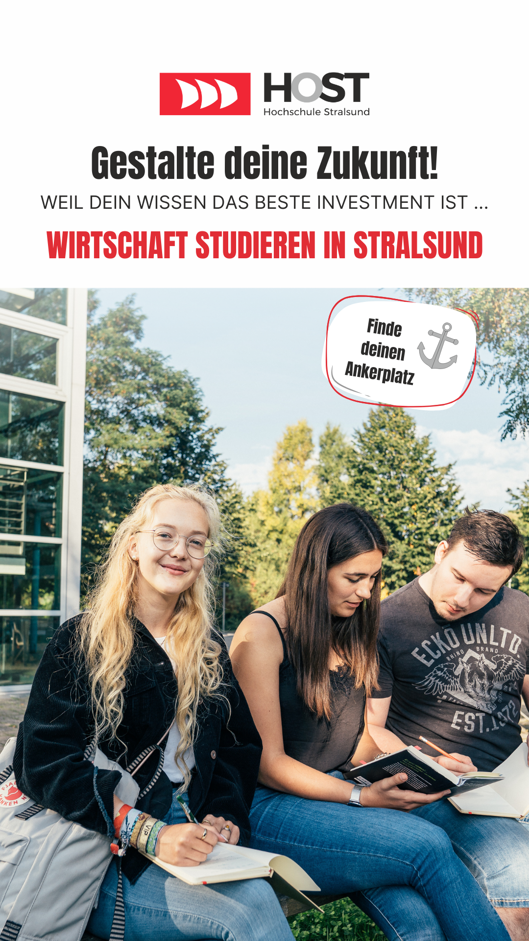 Anzeige. Drei Studenten sitzen im Grünen vor der Fakultät für Wirtschaft und lernen.