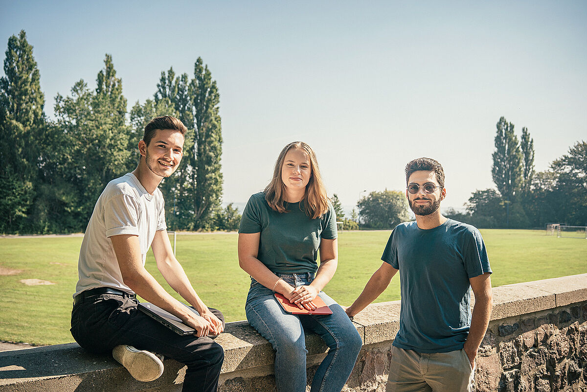 Students sit on wall