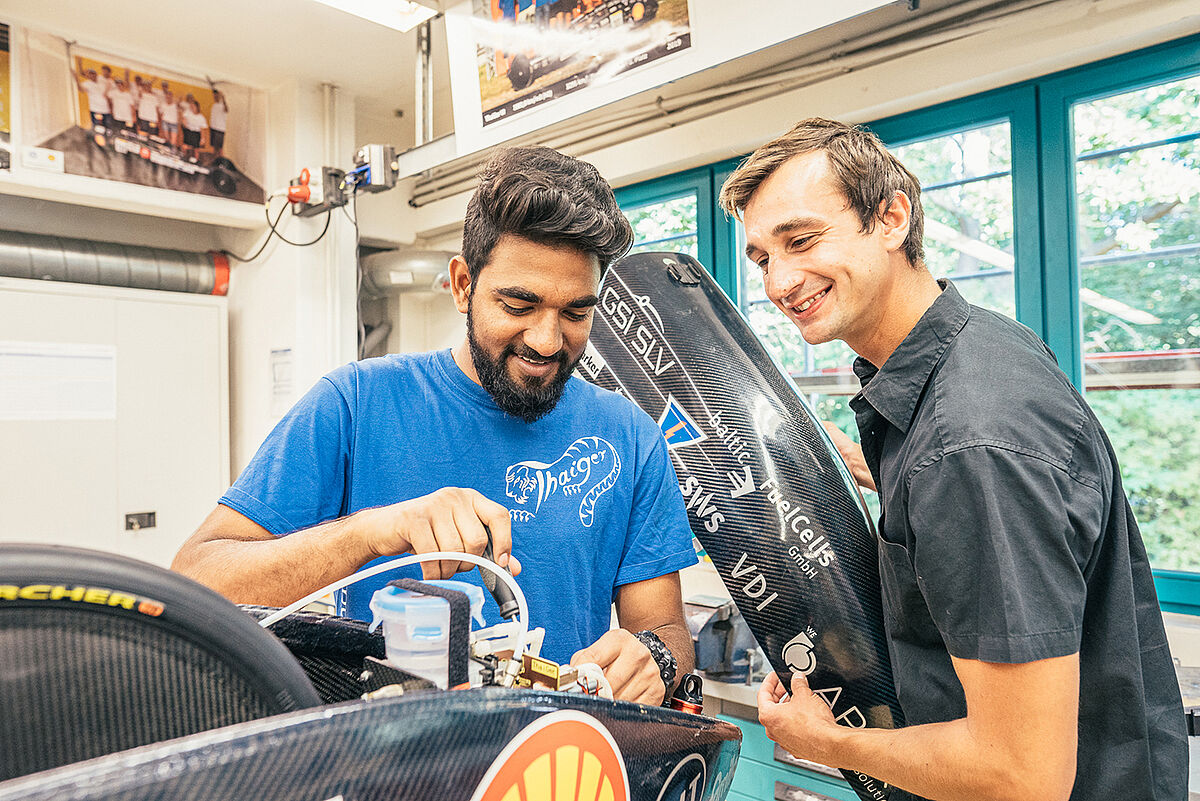 Members of the Thaiger Racing Team work on car