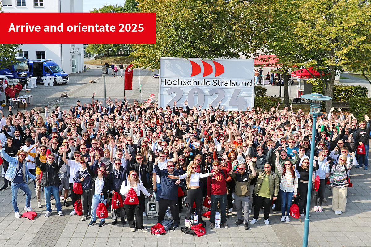 Our first-year students in September 2024 stand in front of the year sign for a group photo
