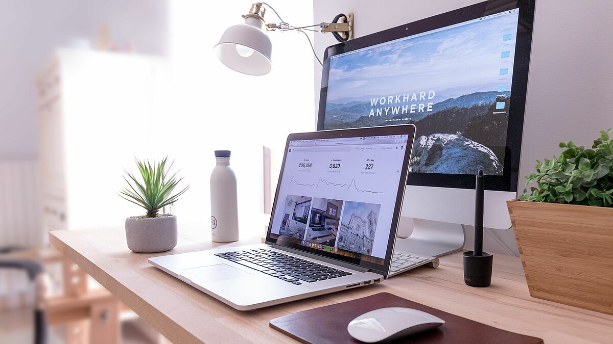 Desk with computer and laptop